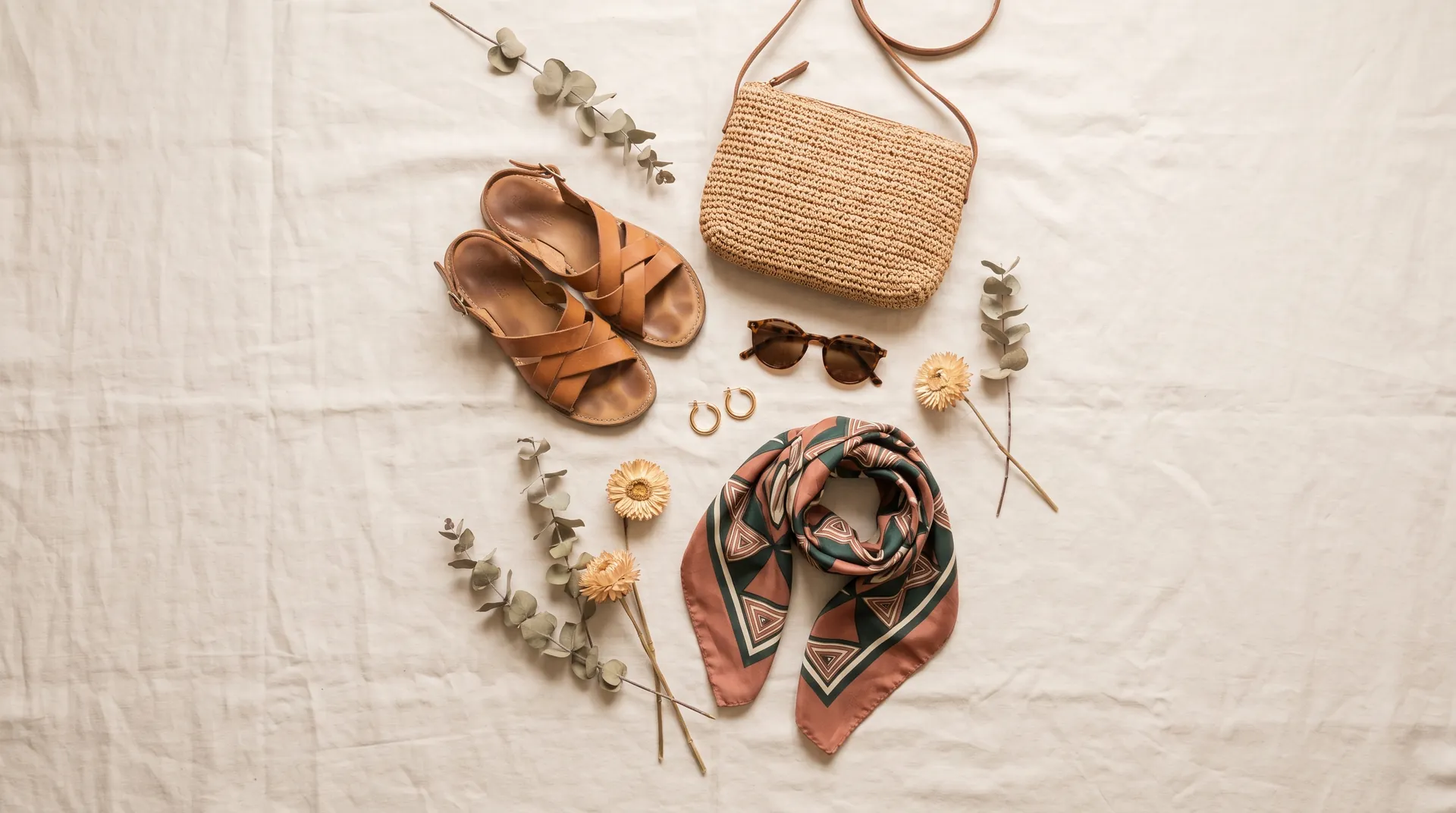 Favourite saved items: leather sandals, a raffia bag, gold hoops, sunglasses and an Ankara scarf